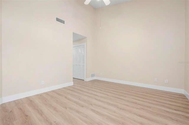 4472 Calle Serena, Sarasota, FL 34238 - spare room featuring light wood-type flooring, baseboards, ceiling fan, and a towering ceiling