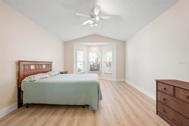 4472 Calle Serena, Sarasota, FL 34238 - bedroom with light wood-type flooring, baseboards, a textured ceiling, lofted ceiling, and ceiling fan