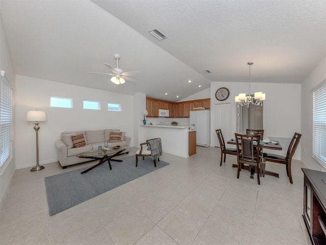12682 Shimmering Oak Cir, Venice, FL 34293 - living area with vaulted ceiling, ceiling fan, a chandelier, and light tile patterned flooring