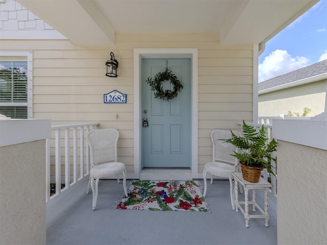 12682 Shimmering Oak Cir, Venice, FL 34293 - doorway to property featuring covered porch