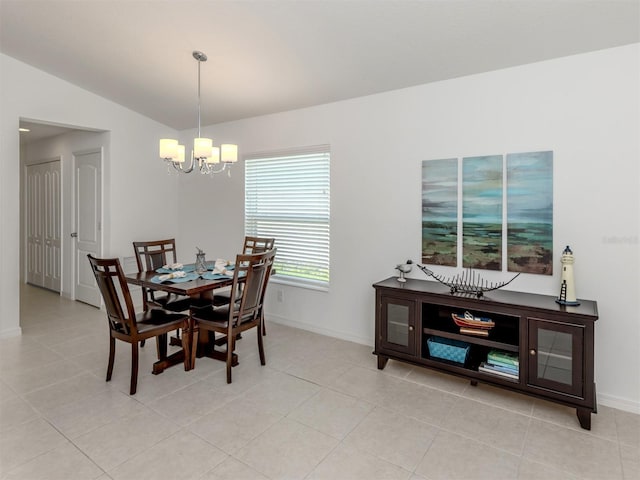 12682 Shimmering Oak Cir, Venice, FL 34293 - dining room featuring a chandelier, vaulted ceiling, and light tile patterned floors