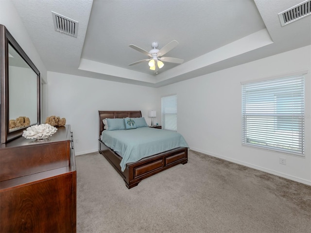 12682 Shimmering Oak Cir, Venice, FL 34293 - carpeted bedroom featuring a raised ceiling and a ceiling fan