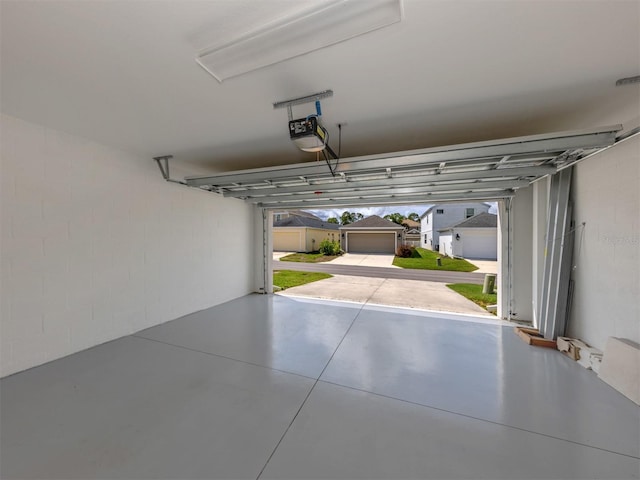 12682 Shimmering Oak Cir, Venice, FL 34293 - garage with a garage door opener and concrete block wall