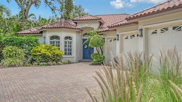 1864 Goldenrod St, Sarasota, FL 34239 - view of front of house featuring a tiled roof, stucco siding, decorative driveway, and a garage