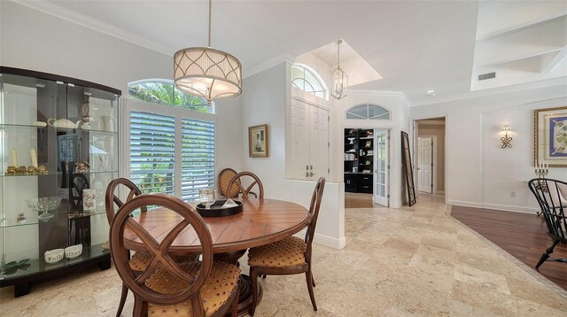 1864 Goldenrod St, Sarasota, FL 34239 - dining room with ornamental molding, a chandelier, and stone finish floors