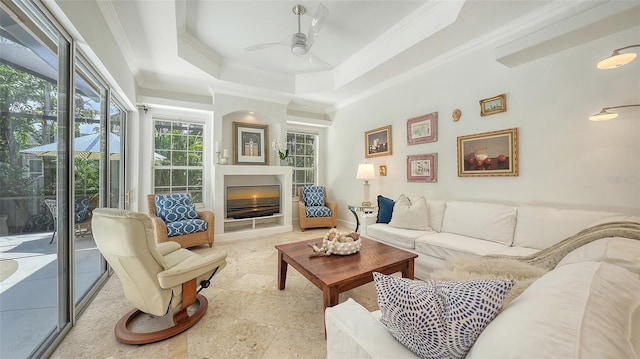 1864 Goldenrod St, Sarasota, FL 34239 - living area featuring ornamental molding, ceiling fan, a fireplace, and a tray ceiling