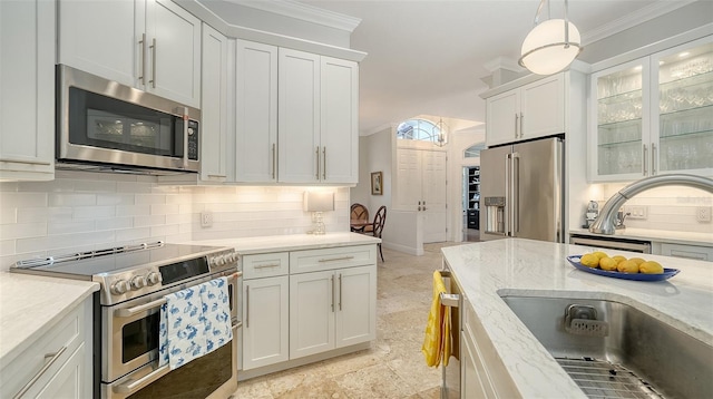 1864 Goldenrod St, Sarasota, FL 34239 - kitchen with stainless steel appliances, decorative backsplash, white cabinetry, glass insert cabinets, and ornamental molding