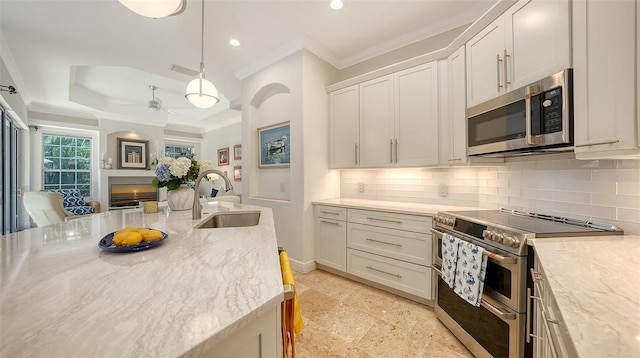 1864 Goldenrod St, Sarasota, FL 34239 - kitchen featuring appliances with stainless steel finishes, crown molding, ceiling fan, backsplash, and recessed lighting