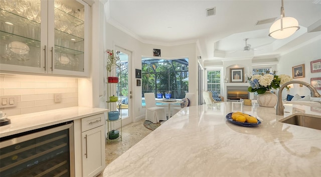 1864 Goldenrod St, Sarasota, FL 34239 - dining room with beverage cooler, ceiling fan, crown molding, and a raised ceiling