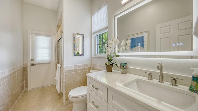 1864 Goldenrod St, Sarasota, FL 34239 - full bath with tile walls, tile patterned floors, a shower with shower curtain, wainscoting, and vanity