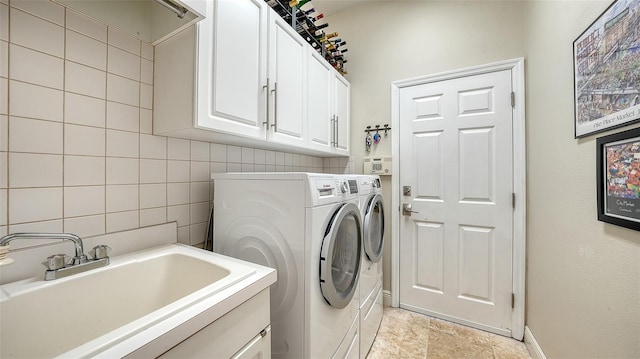 1864 Goldenrod St, Sarasota, FL 34239 - laundry room with cabinet space, separate washer and dryer, tile walls, and light stone finish floors
