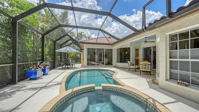 1864 Goldenrod St, Sarasota, FL 34239 - view of swimming pool with a patio area, a pool with connected hot tub, ceiling fan, and glass enclosure