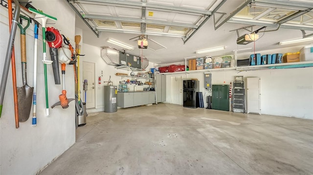 1864 Goldenrod St, Sarasota, FL 34239 - garage featuring electric water heater, a garage door opener, electric panel, and freestanding refrigerator