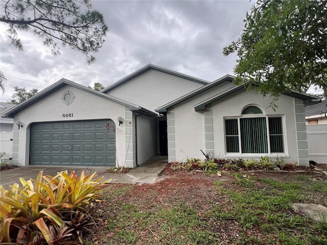 4441 Groveland Ave, Sarasota, FL 34231 - ranch-style house featuring stucco siding, an attached garage, and driveway
