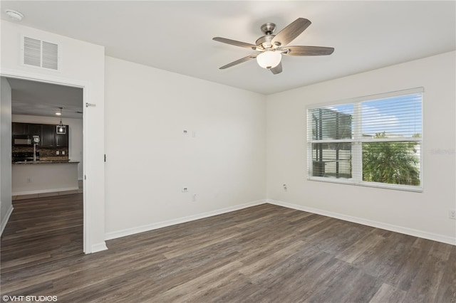 4005 Willow Branch Pl, Palmetto, FL 34221 - empty room with dark wood-style flooring, ceiling fan, and baseboards