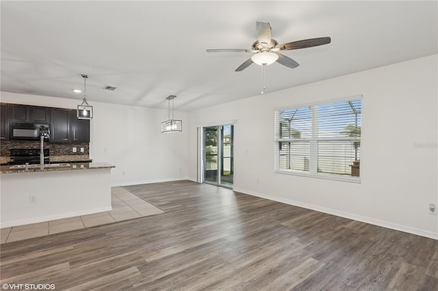 4005 Willow Branch Pl, Palmetto, FL 34221 - unfurnished living room with wood finished floors, ceiling fan, baseboards, and recessed lighting