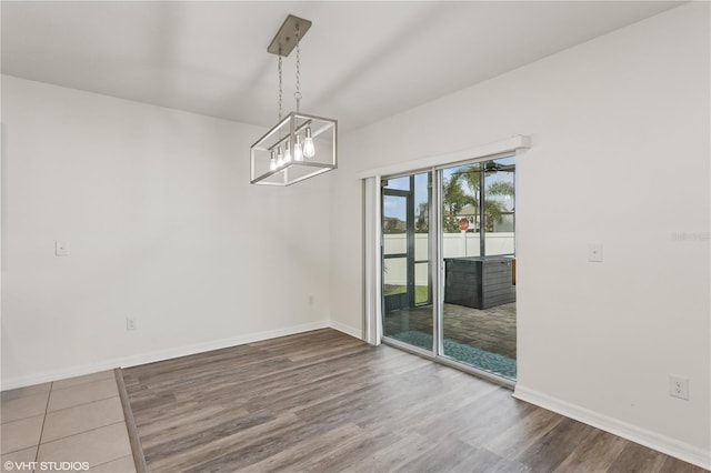 4005 Willow Branch Pl, Palmetto, FL 34221 - unfurnished dining area with wood finished floors, baseboards, and a chandelier