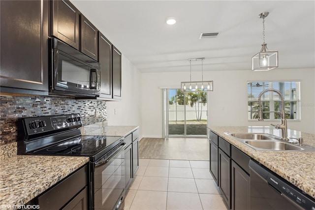 4005 Willow Branch Pl, Palmetto, FL 34221 - kitchen with black appliances, a sink, decorative backsplash, dark brown cabinetry, and decorative light fixtures