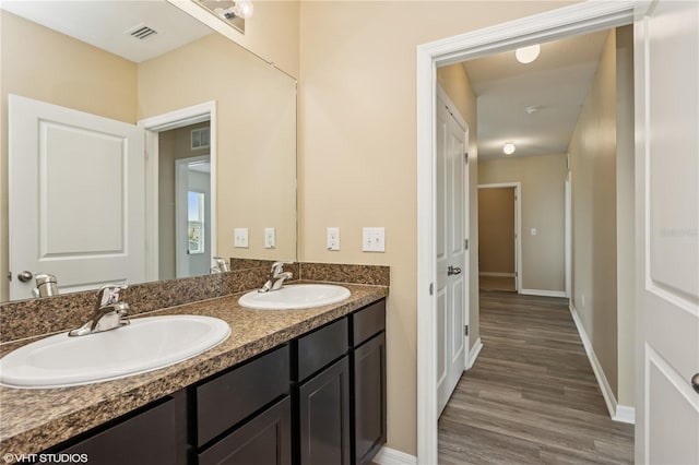 4005 Willow Branch Pl, Palmetto, FL 34221 - bathroom with double vanity, wood finished floors, and baseboards