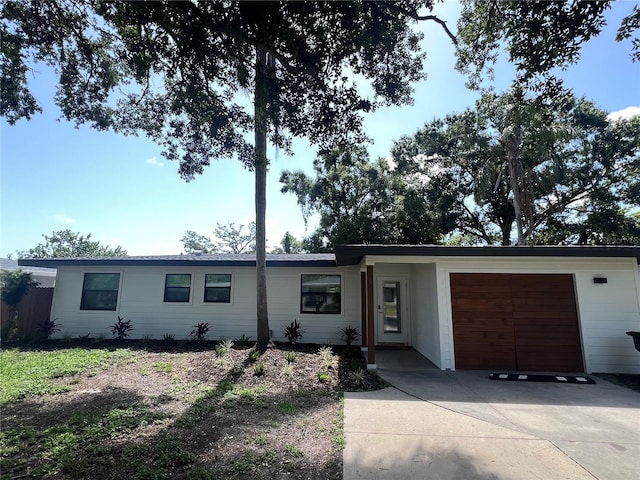 4460 Emerald Ridge Dr, Sarasota, FL 34233 - ranch-style home featuring an attached garage and concrete driveway