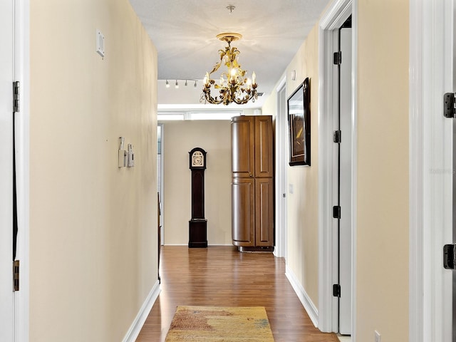 1233 N Gulfstream Ave Unit 401, Sarasota, FL 34236 - hallway with wood finished floors, a chandelier, and baseboards