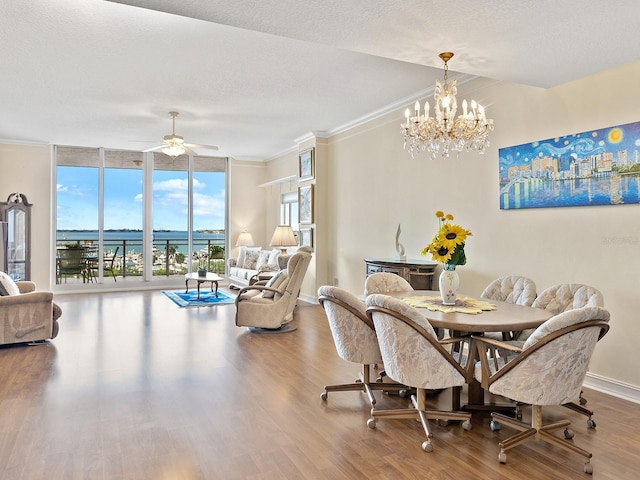 1233 N Gulfstream Ave Unit 401, Sarasota, FL 34236 - dining area featuring wood finished floors, a wall of windows, a chandelier, crown molding, and a ceiling fan