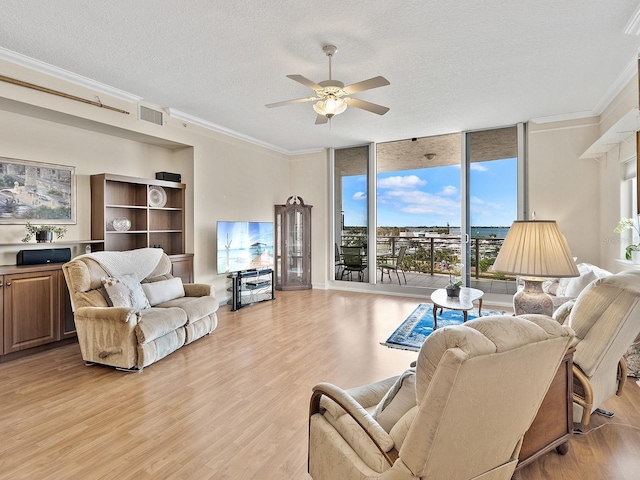 1233 N Gulfstream Ave Unit 401, Sarasota, FL 34236 - living area with a textured ceiling, light wood-style floors, ceiling fan, crown molding, and floor to ceiling windows