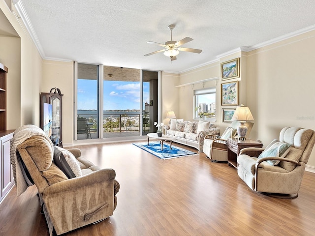 1233 N Gulfstream Ave Unit 401, Sarasota, FL 34236 - living room with a textured ceiling, wood finished floors, a ceiling fan, and crown molding