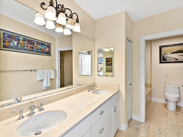 1233 N Gulfstream Ave Unit 401, Sarasota, FL 34236 - bathroom featuring double vanity, toilet, a chandelier, baseboards, and tile patterned flooring