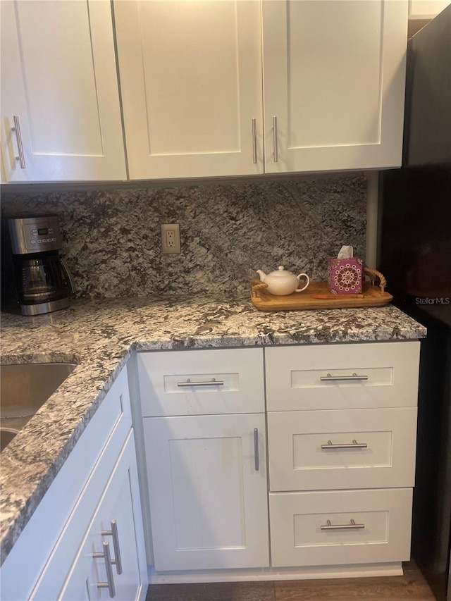 4520 47th Ave W Unit 103, Bradenton, FL 34210 - kitchen featuring backsplash, white cabinets, and light stone countertops