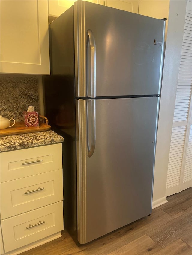 4520 47th Ave W Unit 103, Bradenton, FL 34210 - kitchen featuring freestanding refrigerator, wood finished floors, and white cabinets