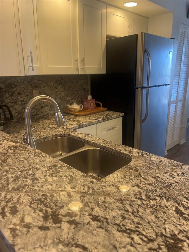 4520 47th Ave W Unit 103, Bradenton, FL 34210 - kitchen with a sink, white cabinets, dark stone counters, and freestanding refrigerator