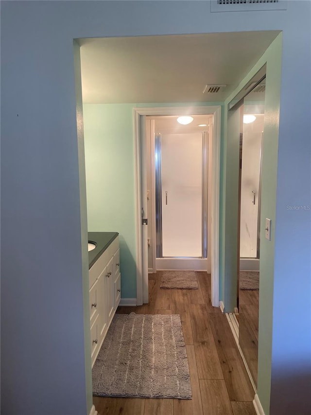 4520 47th Ave W Unit 103, Bradenton, FL 34210 - bathroom featuring vanity, wood finished floors, and baseboards
