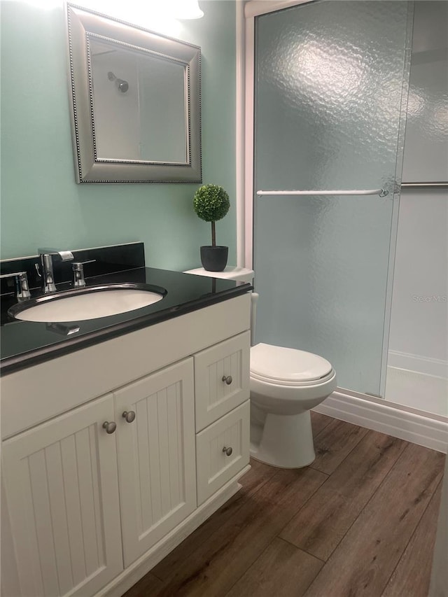4520 47th Ave W Unit 103, Bradenton, FL 34210 - full bathroom with wood finished floors, vanity, a stall shower, and toilet