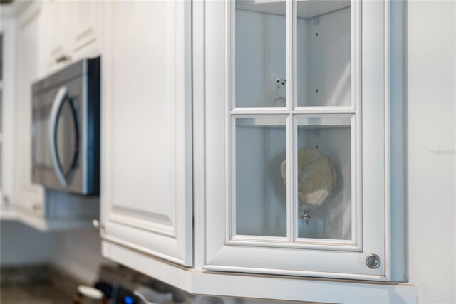 525 N Orange Ave Unit 302, Sarasota, FL 34236 - kitchen view of stainless steel microwave and glass insert cabinets