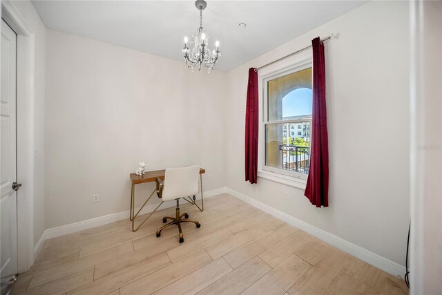 525 N Orange Ave Unit 302, Sarasota, FL 34236 - unfurnished office featuring a chandelier, wood finished floors, and baseboards