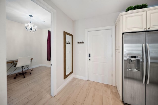 525 N Orange Ave Unit 302, Sarasota, FL 34236 - kitchen featuring stainless steel fridge with ice dispenser, a chandelier, light wood finished floors, and baseboards