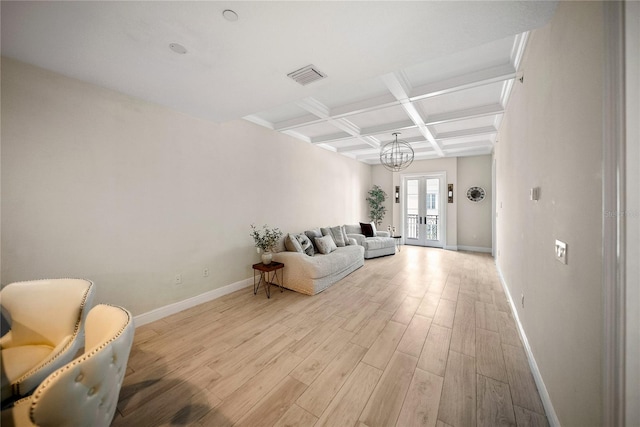 525 N Orange Ave Unit 302, Sarasota, FL 34236 - living area with light wood-style floors, coffered ceiling, baseboards, beam ceiling, and a chandelier