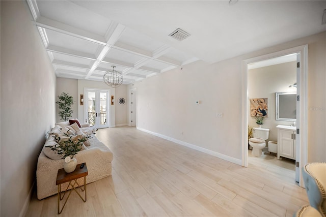 525 N Orange Ave Unit 302, Sarasota, FL 34236 - living area featuring coffered ceiling, beamed ceiling, baseboards, light wood-style floors, and a chandelier