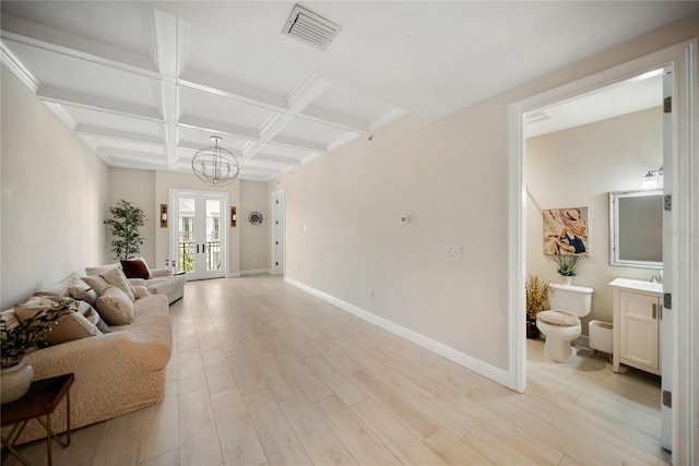 525 N Orange Ave Unit 302, Sarasota, FL 34236 - living room with a chandelier, light wood finished floors, baseboards, beam ceiling, and coffered ceiling