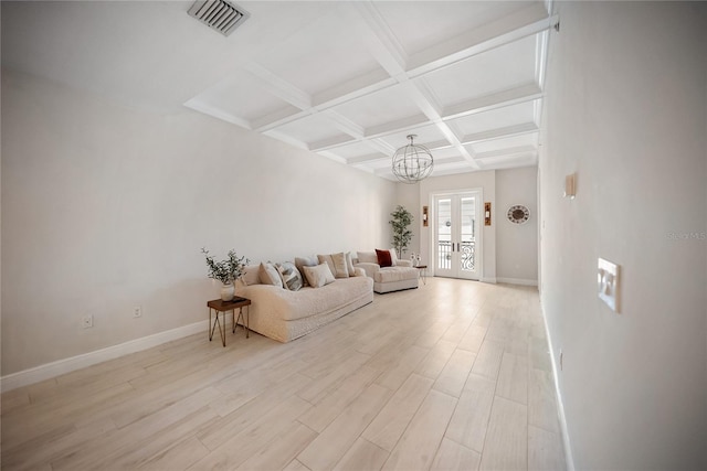 525 N Orange Ave Unit 302, Sarasota, FL 34236 - living room with coffered ceiling, beamed ceiling, baseboards, light wood-type flooring, and a chandelier