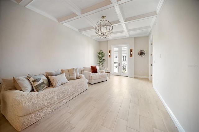 525 N Orange Ave Unit 302, Sarasota, FL 34236 - living area with coffered ceiling, a chandelier, baseboards, beamed ceiling, and light wood-style flooring