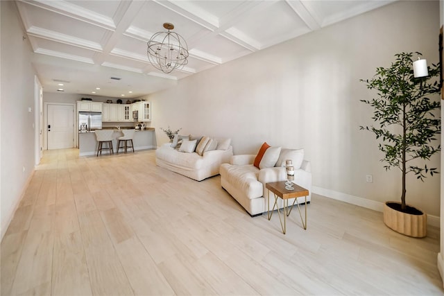 525 N Orange Ave Unit 302, Sarasota, FL 34236 - living room featuring coffered ceiling, beam ceiling, a chandelier, baseboards, and light wood-style flooring