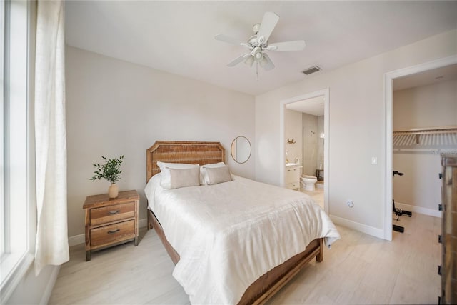 525 N Orange Ave Unit 302, Sarasota, FL 34236 - bedroom featuring light wood-style floors, ensuite bathroom, baseboards, ceiling fan, and a spacious closet