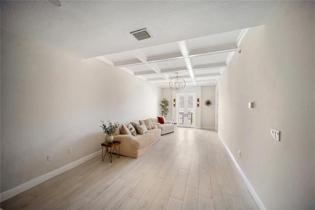 525 N Orange Ave Unit 302, Sarasota, FL 34236 - living room with beamed ceiling, a chandelier, coffered ceiling, light wood-style flooring, and baseboards