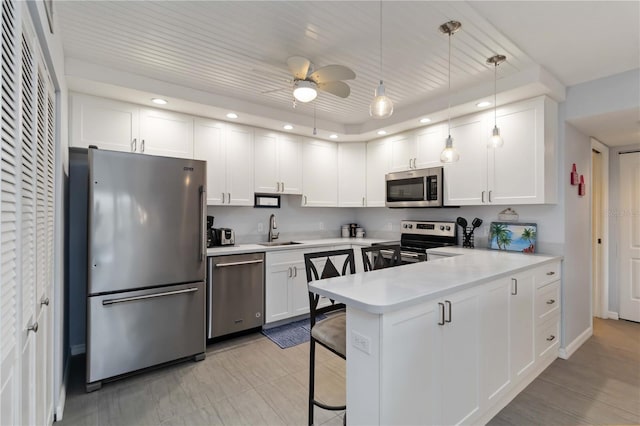 2729 N Beach Rd Unit 212, Englewood, FL 34223 - kitchen featuring appliances with stainless steel finishes, a sink, a peninsula, recessed lighting, and white cabinetry