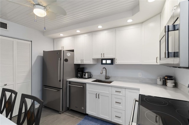 2729 N Beach Rd Unit 212, Englewood, FL 34223 - kitchen with appliances with stainless steel finishes, a sink, recessed lighting, white cabinets, and light countertops