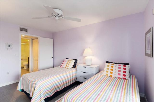 2729 N Beach Rd Unit 212, Englewood, FL 34223 - bedroom featuring baseboards, wood finished floors, ceiling fan, and ensuite bathroom
