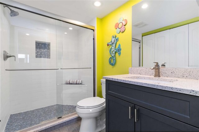 2729 N Beach Rd Unit 212, Englewood, FL 34223 - bathroom with vanity, a shower stall, toilet, and recessed lighting