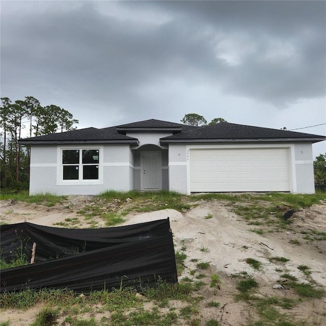 3542 Eldron Ave, North Port, FL 34286 - prairie-style house with stucco siding and a garage